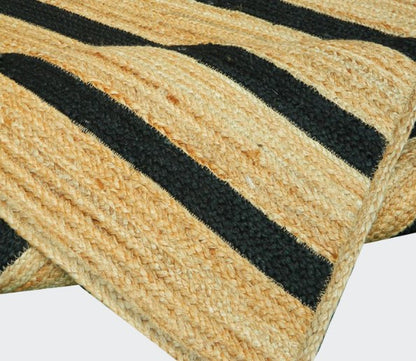 Close-up of a woven doormat with black stripes on a white background