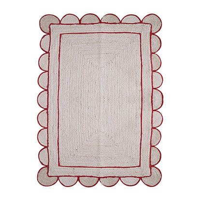 Rectangular rug with scalloped red border on a white background