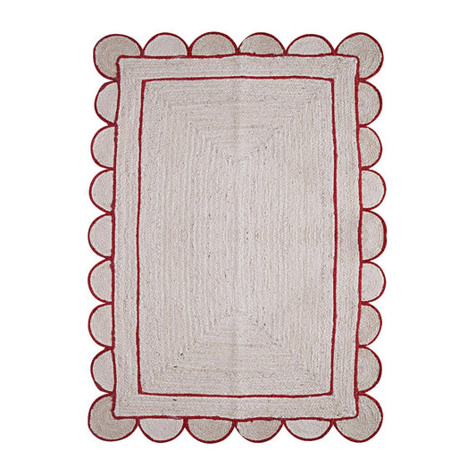 Rectangular rug with scalloped red border on a white background