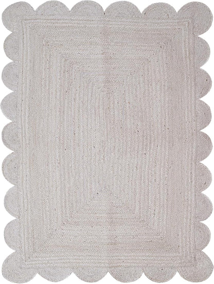Gray braided rug with scalloped edge on a white background