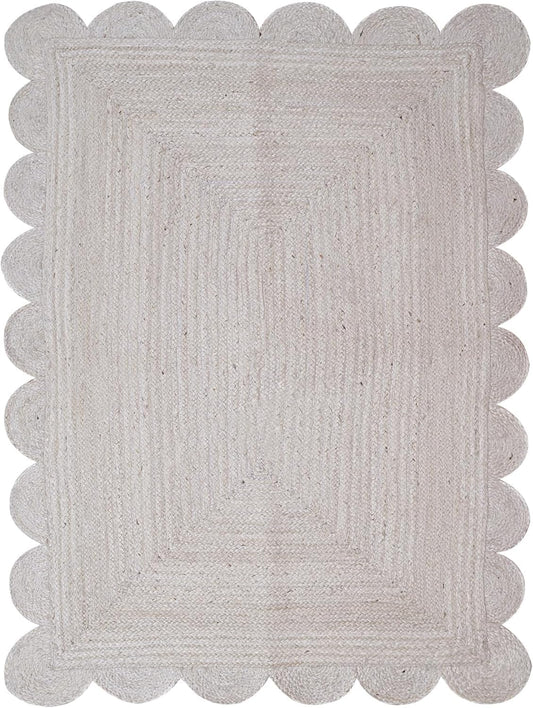 Gray braided rug with scalloped edge on a white background