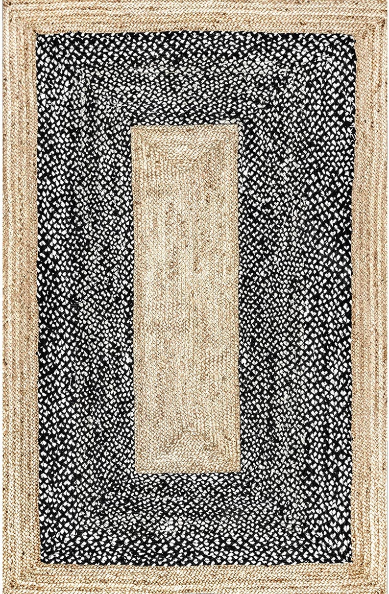 Rug with a black and white patterned border and beige center