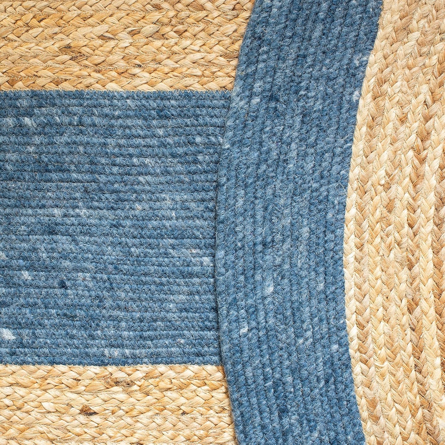 Blue and natural woven jute rug, featuring a textured design with braided elements.