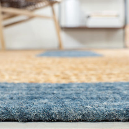 Blue wool rug with a textured surface, ideal for cozy living spaces.