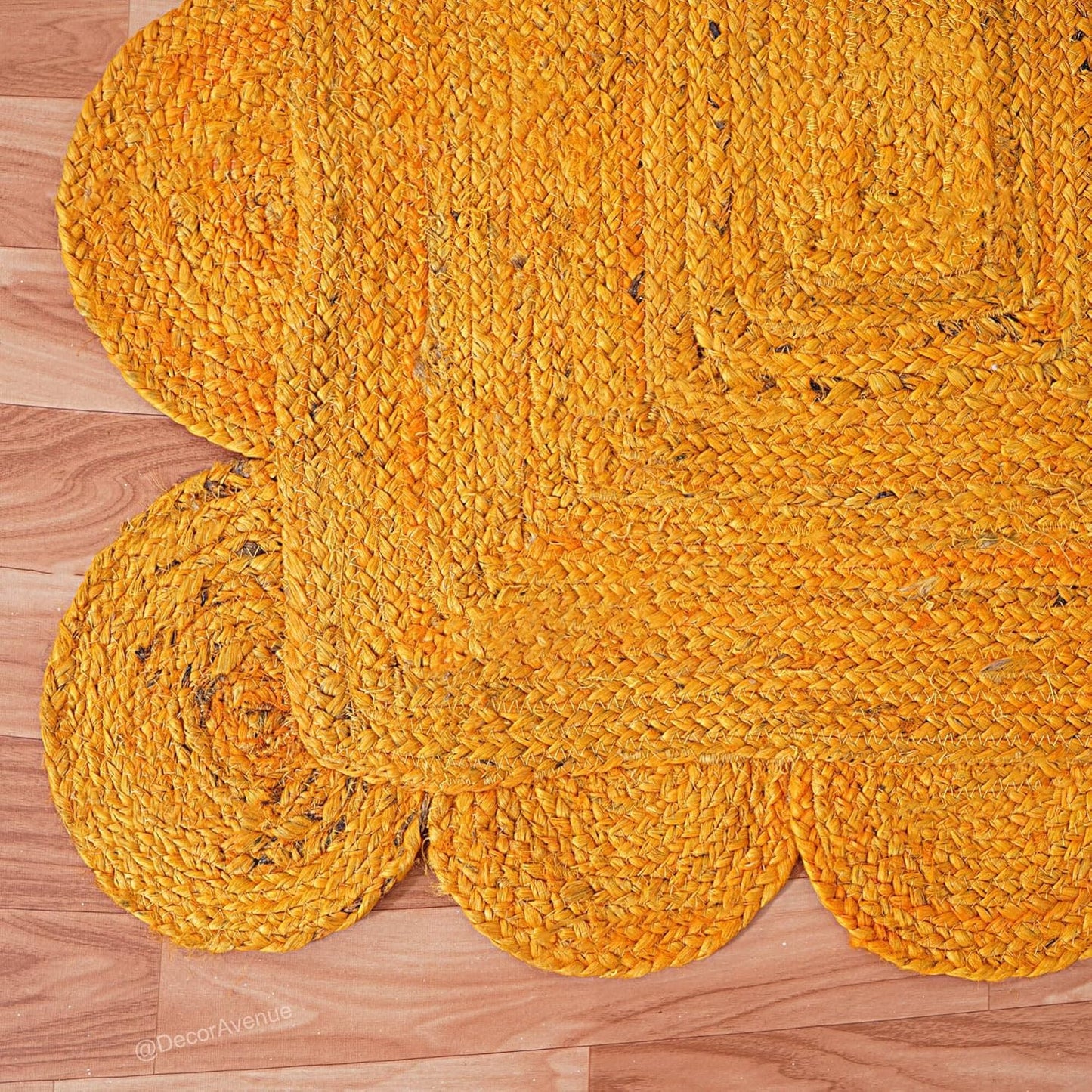 Yellow braided rug on a wooden floor