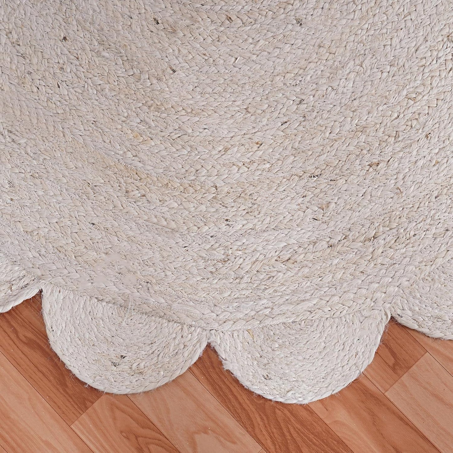 Beige braided rug on a wooden floor