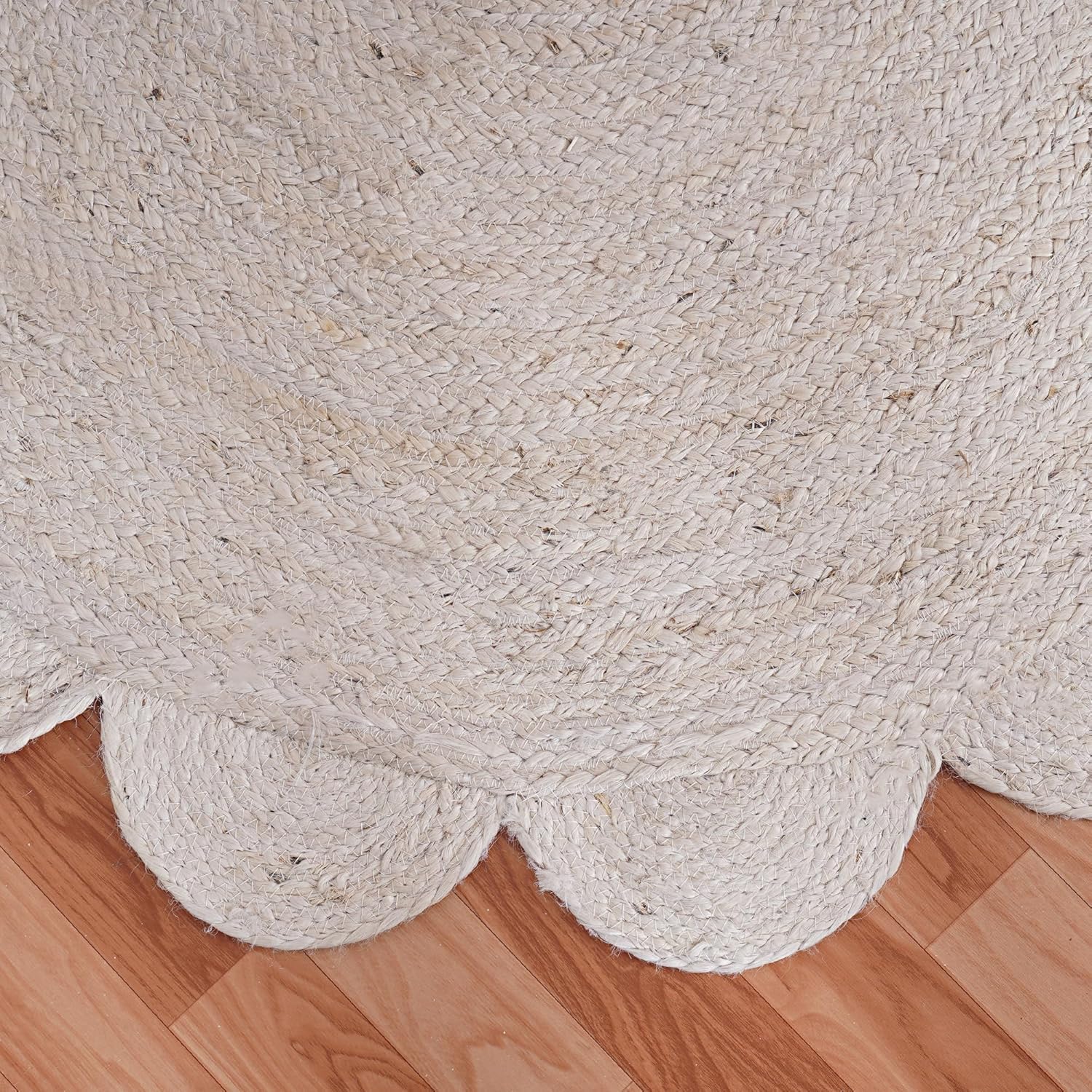 Beige braided rug on a wooden floor