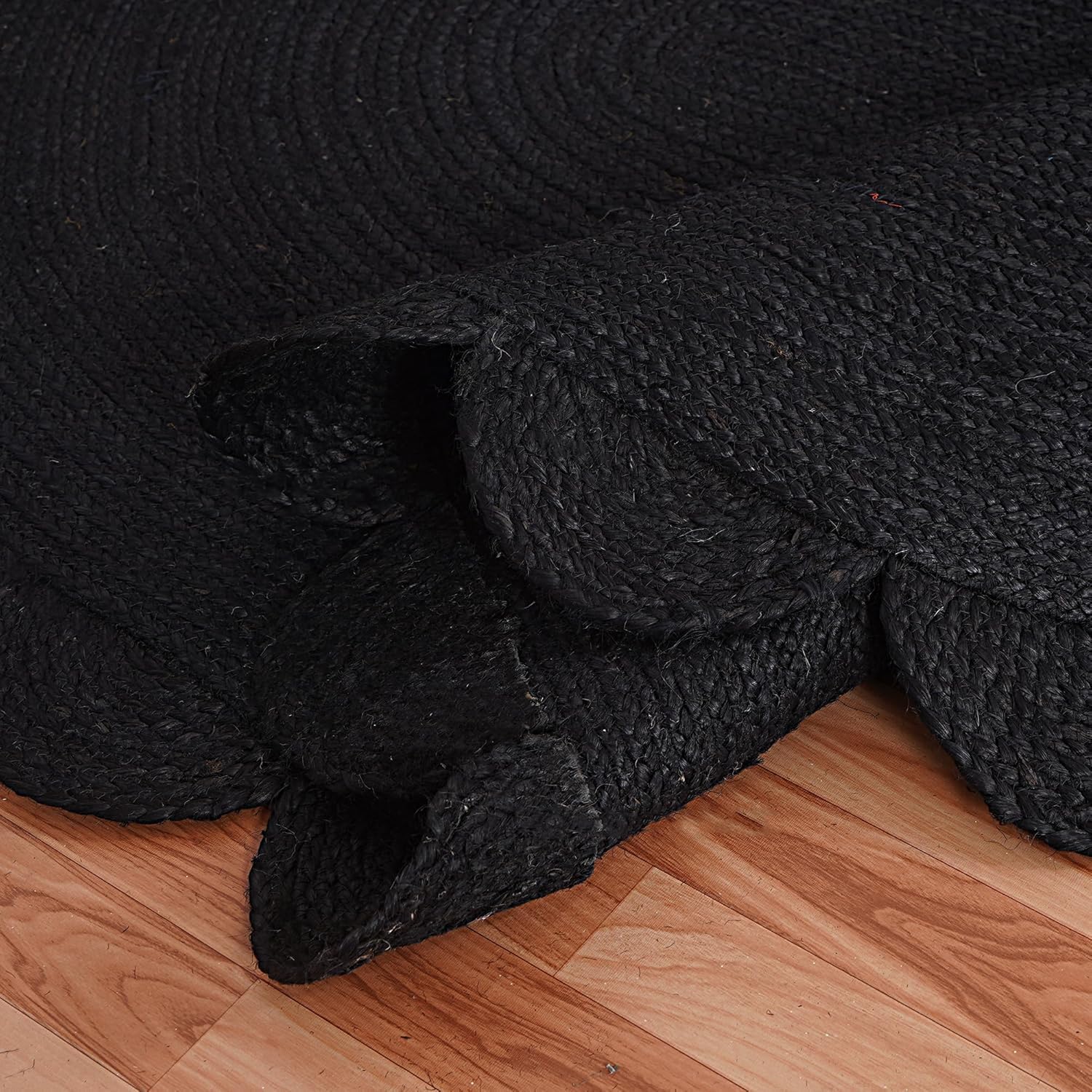 Black textured rug on a wooden floor