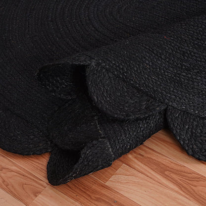 Black textured rug on a wooden floor