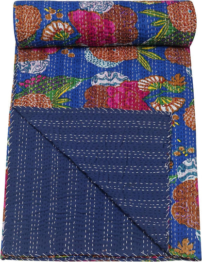 Colorful floral-patterned fabric rolled up on a blue background