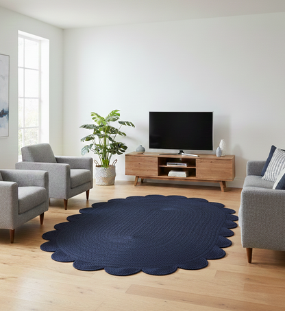 navy blue round jute rug with scalloped edges in living room setting