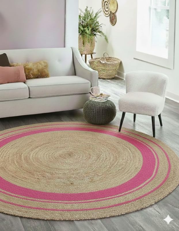 Round jute rug with pink border in a living room setting