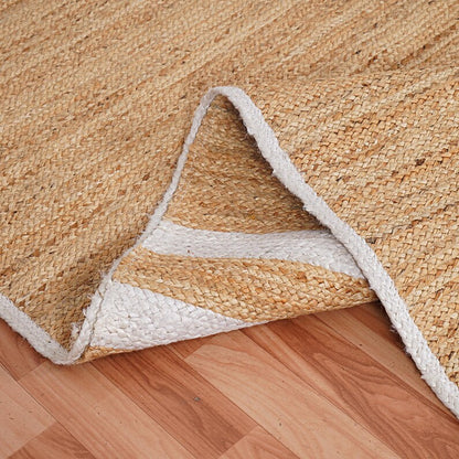 Close-up of a woven natural fiber rug on a wooden floor