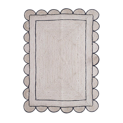 Rectangular rug with scalloped edge on a white background