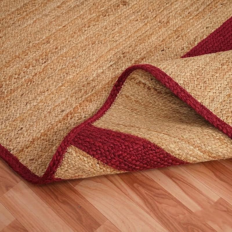Natural Jute Area Rug with maroon border, textured natural fiber floor carpet rug on hardwood floor