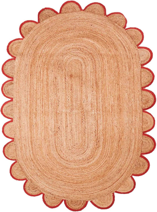 Oval jute rug with red scalloped edges, perfect for adding warmth to any room decor.