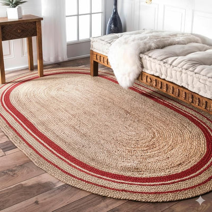 Round jute rug with red stripes on a wooden floor in a bedroom.