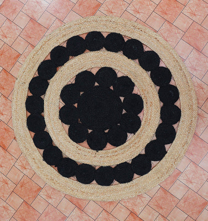 Round rug with black circular patterns on a tiled floor