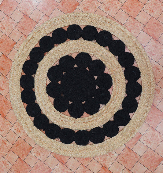 Round rug with black circular patterns on a tiled floor