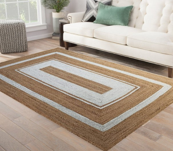 Rectangular area rug with brown and beige pattern in a living room setting.