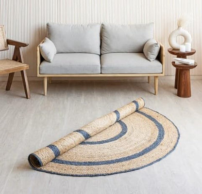 Handwoven jute rug in natural and navy colors, featuring a circular design, perfect for modern living spaces.
