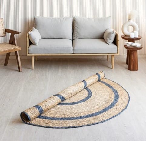 Handwoven jute rug in natural and navy colors, featuring a circular design, perfect for modern living spaces.