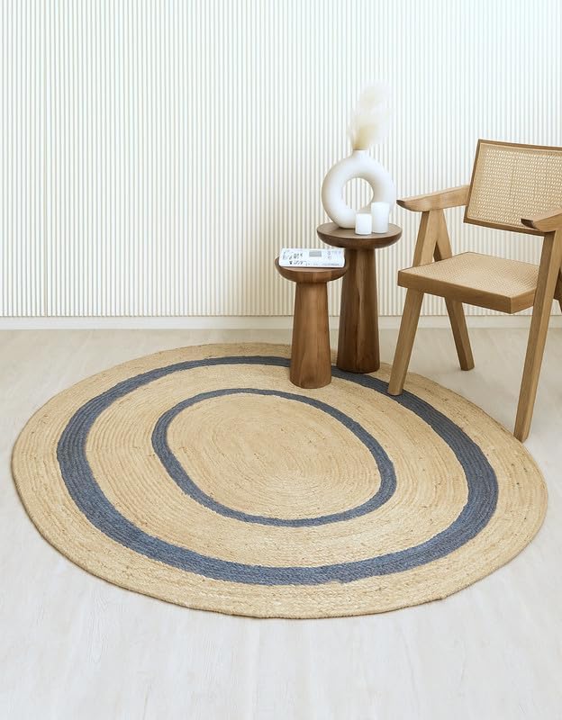 Round jute rug with blue stripes, perfect for modern decor. Soft, natural material for cozy spaces.