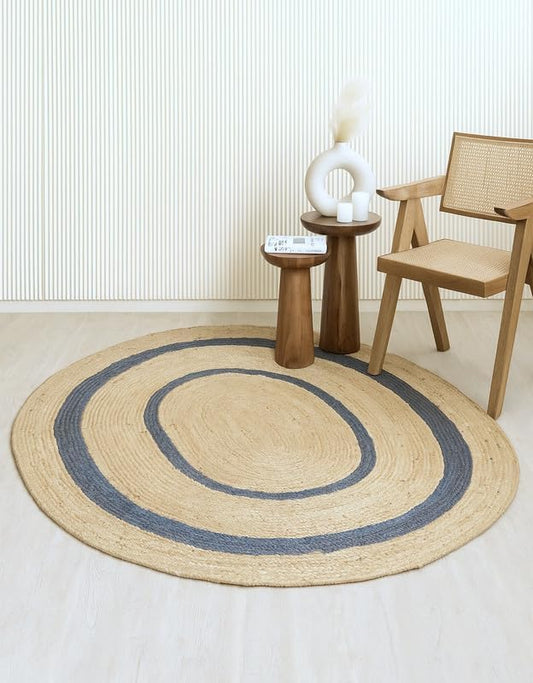 Round jute rug with blue stripes, perfect for modern decor. Soft, natural material for cozy spaces.