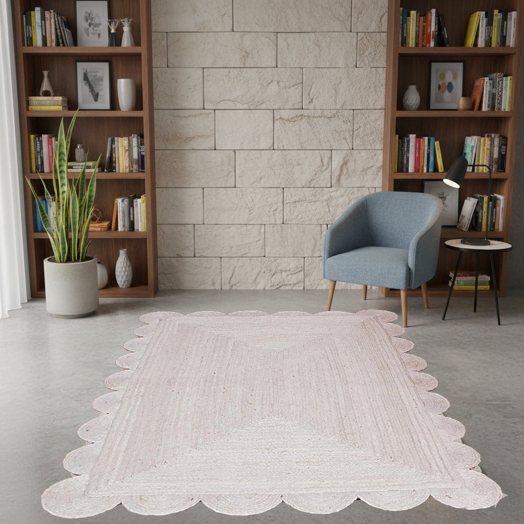 Living room with a white rug, bookshelves, and a blue chair.