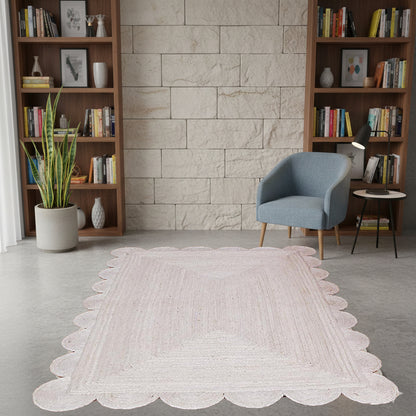 Living room with a white rug, bookshelves, and a blue chair.