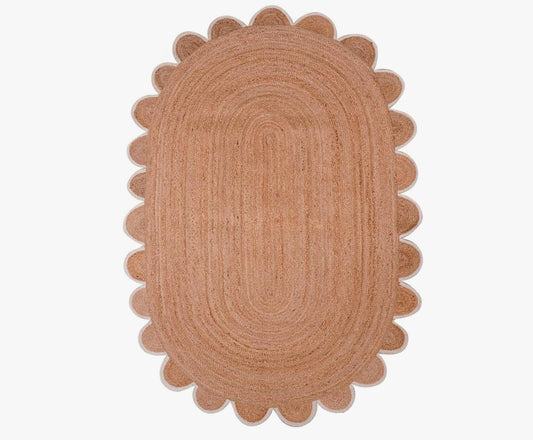 Oval jute rug in warm brown with scalloped edges, ideal for cozy home decor.