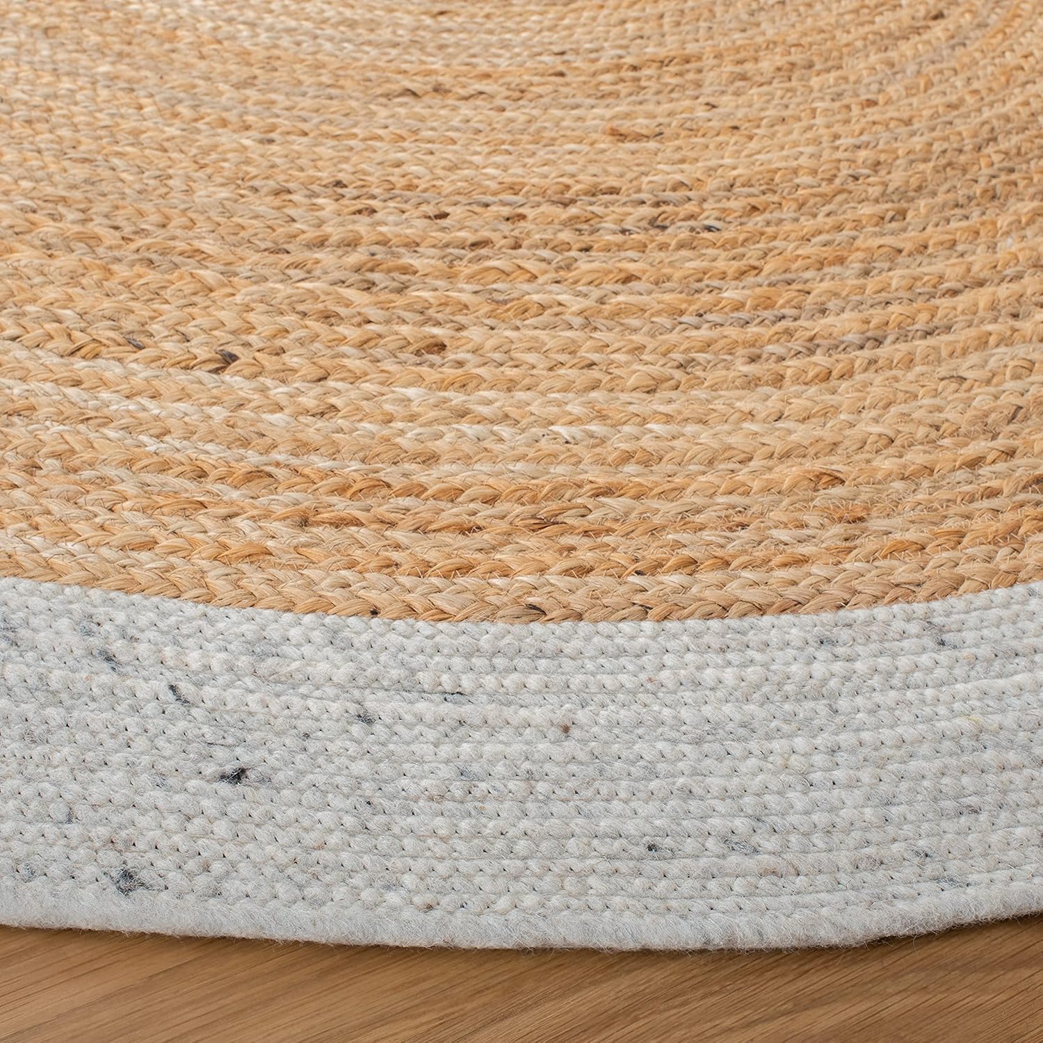 Natural jute rug with a soft cotton border, round shape, and earthy tones for a cozy home decor.
