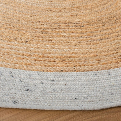 Natural jute rug with a soft cotton border, round shape, and earthy tones for a cozy home decor.