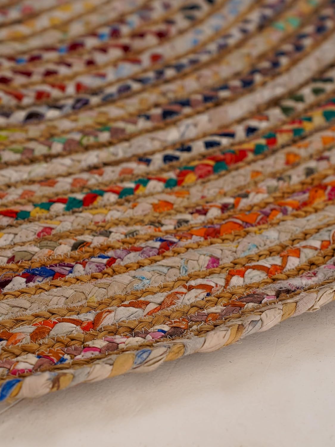 Colorful woven jute rug with vibrant fabric accents, perfect for adding texture to any space.